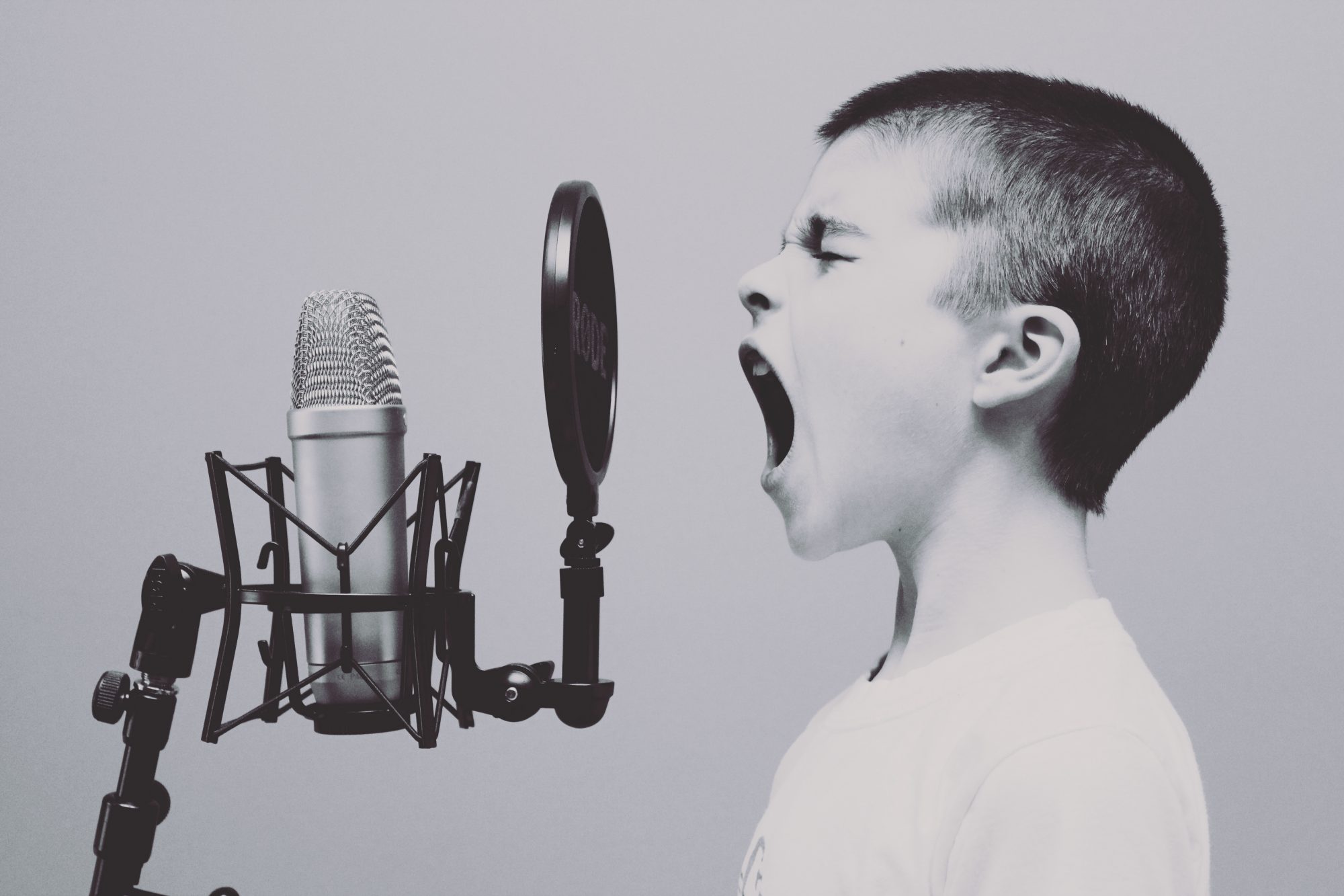 Boy singing into a microphone