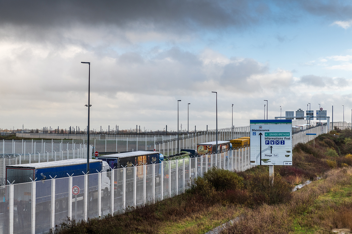 Calais, France - December  17, 2020 : As Brexit approaches, lines of trucks at the entrance to the Channel Tunnel