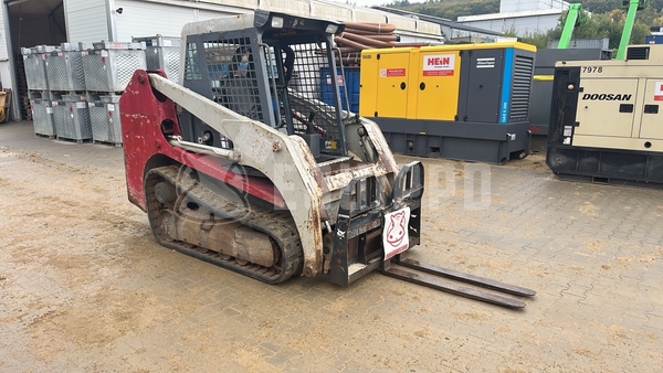 Picture of the Takeuchi TL130 with forks and loader bucket