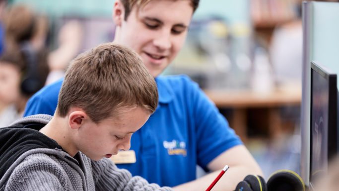Student and tutor working together in Explore centre