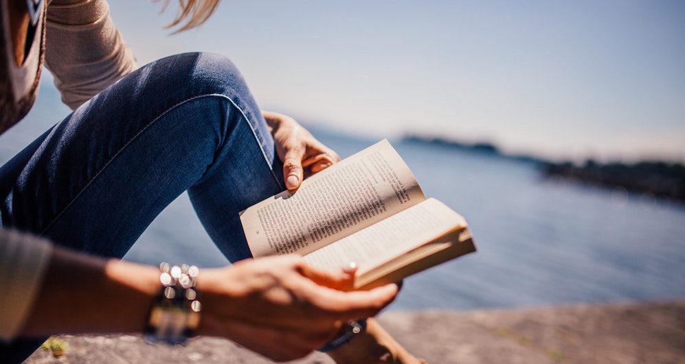 Reading a book by the sea