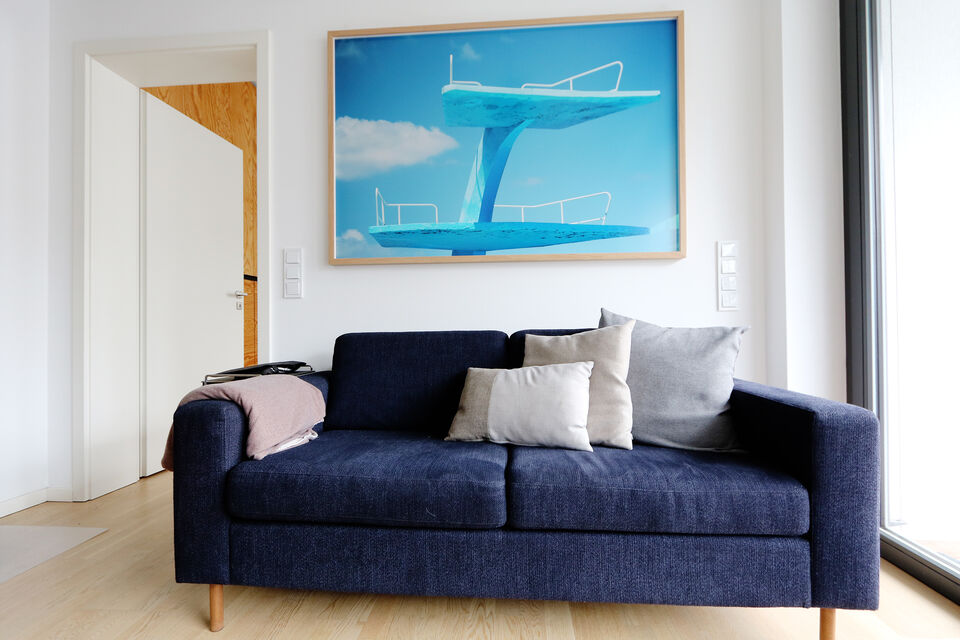 Furnished apartment, living room with dark blue sofa in Berlin Mitte