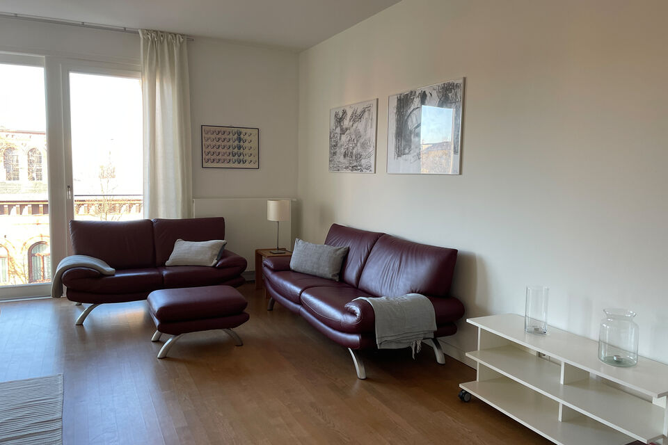 Furnished apartment, living room with leather sofa in Berlin Prenzlauer Berg