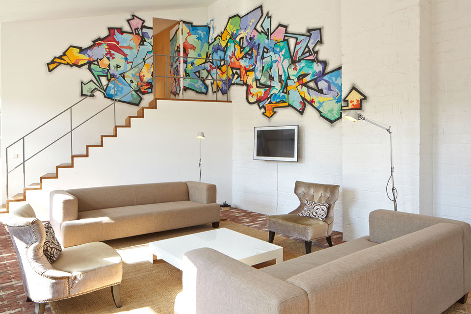 Furnished apartment, living room with colorful graffiti artwork in Berlin Friedrichshain