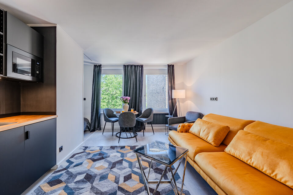 Furnished apartment, living room with orange leather sofa in Berlin Kreuzberg