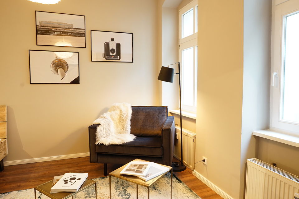 Furnished apartment, living room with leather armchair in Berlin Prenzlauer Berg