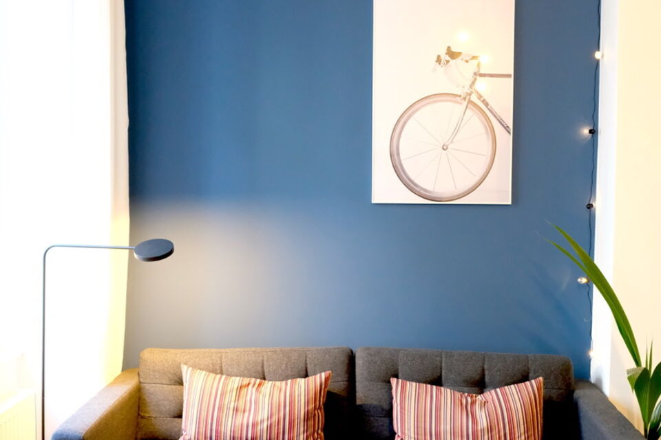 Furnished apartment, living room with bicycle wall art in Berlin Friedrichshain
