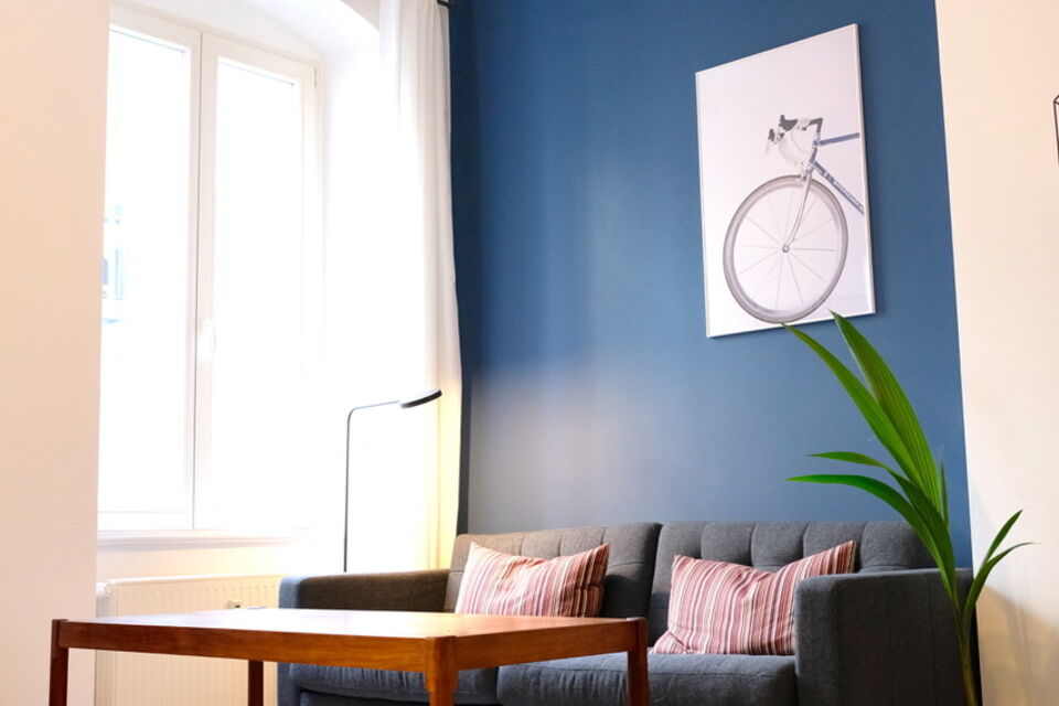 Furnished apartment, living room with blue accent wall in Berlin Friedrichshain