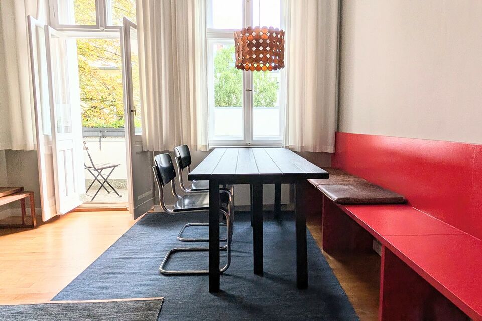 Furnished apartment, dining room with red banquette seating in Berlin Charlottenburg