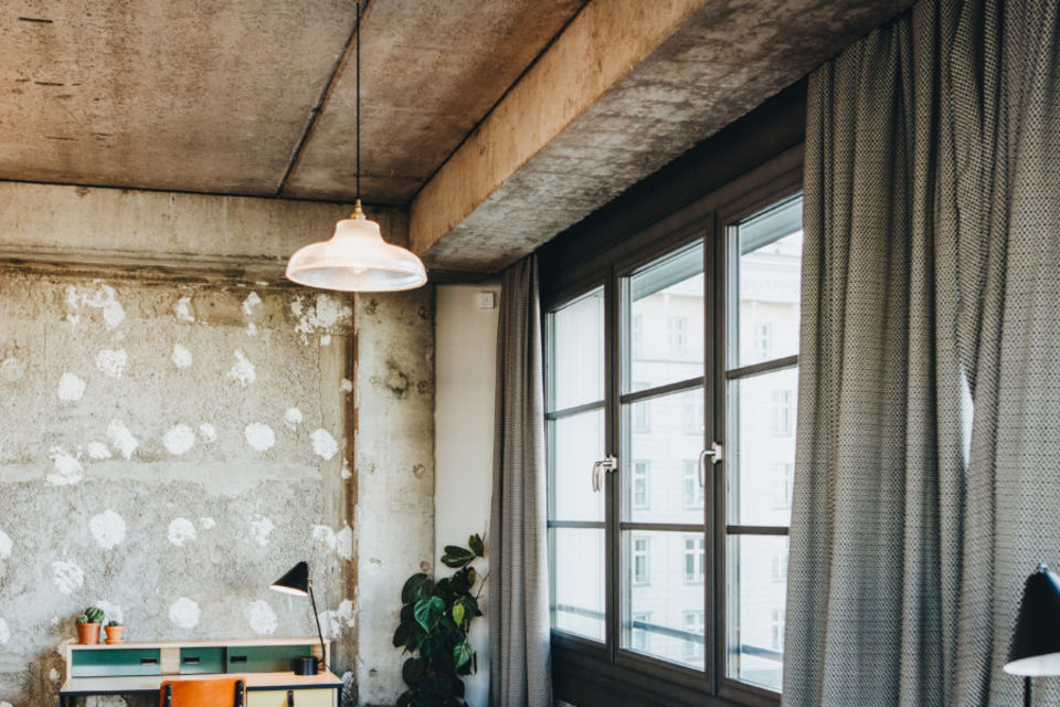 Serviced apartment, living room with exposed concrete ceiling in Berlin Friedrichshain