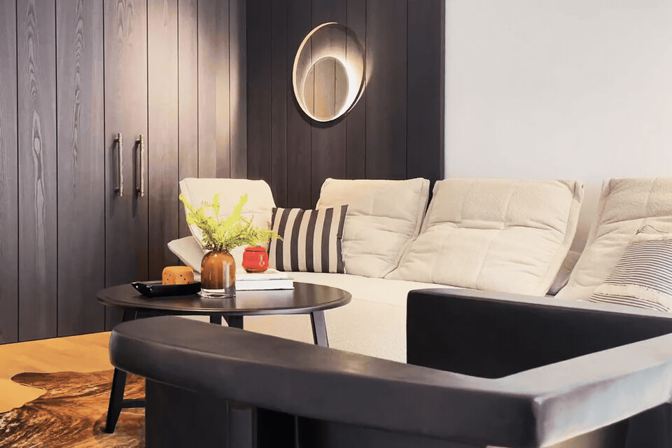 Furnished apartment, living room with cream-colored corner sofa in Berlin Mitte