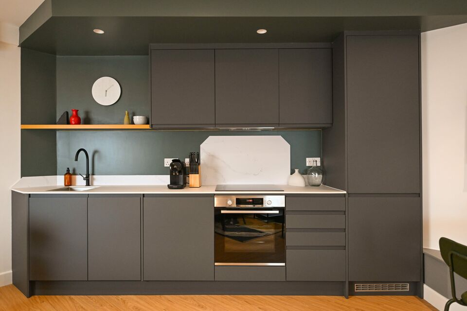 Serviced apartment, kitchen with modern grey fitted cabinetry in London City of London