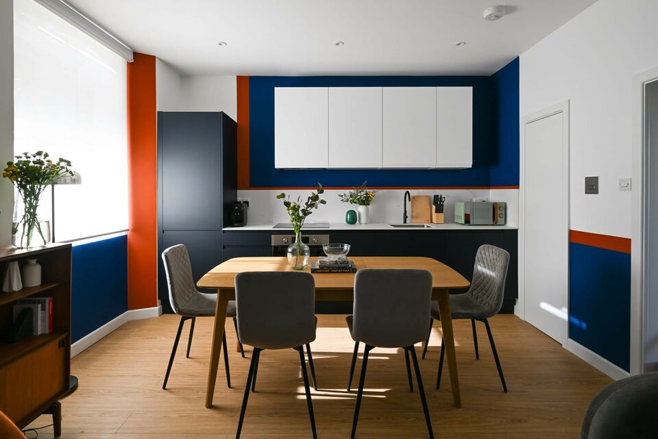 Furnished apartment, dining room with bold accent wall in London City of London