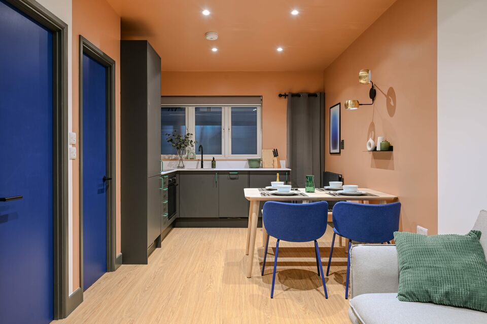 Serviced apartment, kitchen with orange accent wall in London City of London