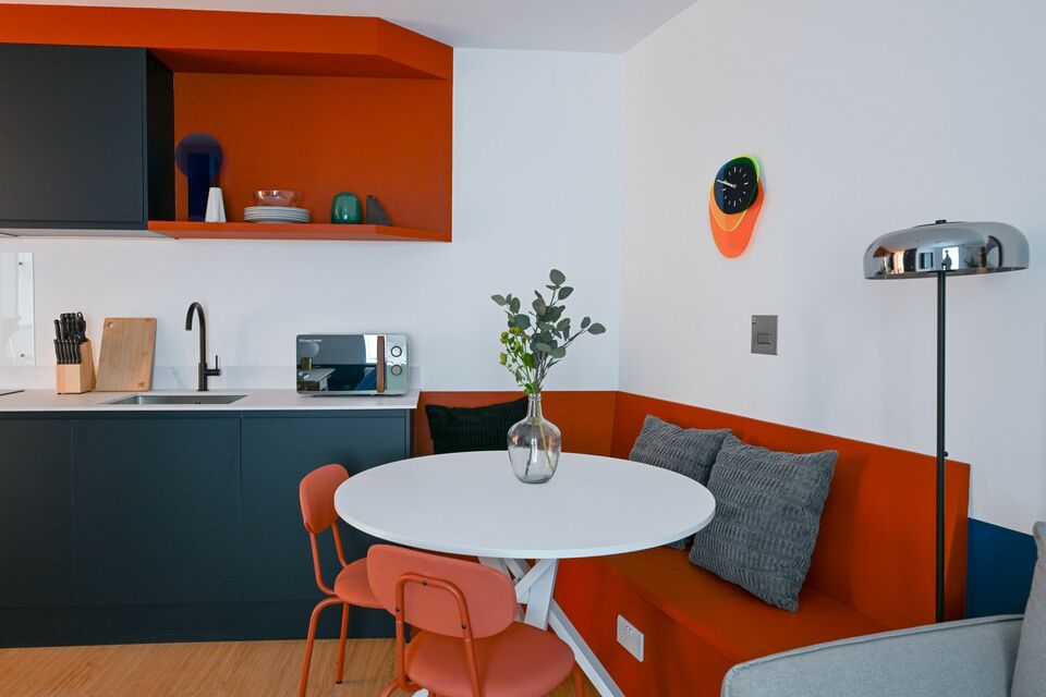 Serviced apartment, kitchen with orange accent design in London City of London