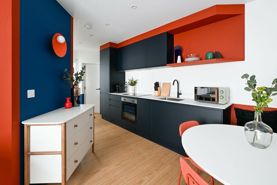 Serviced apartment, kitchen with modern orange and black design in London City of London