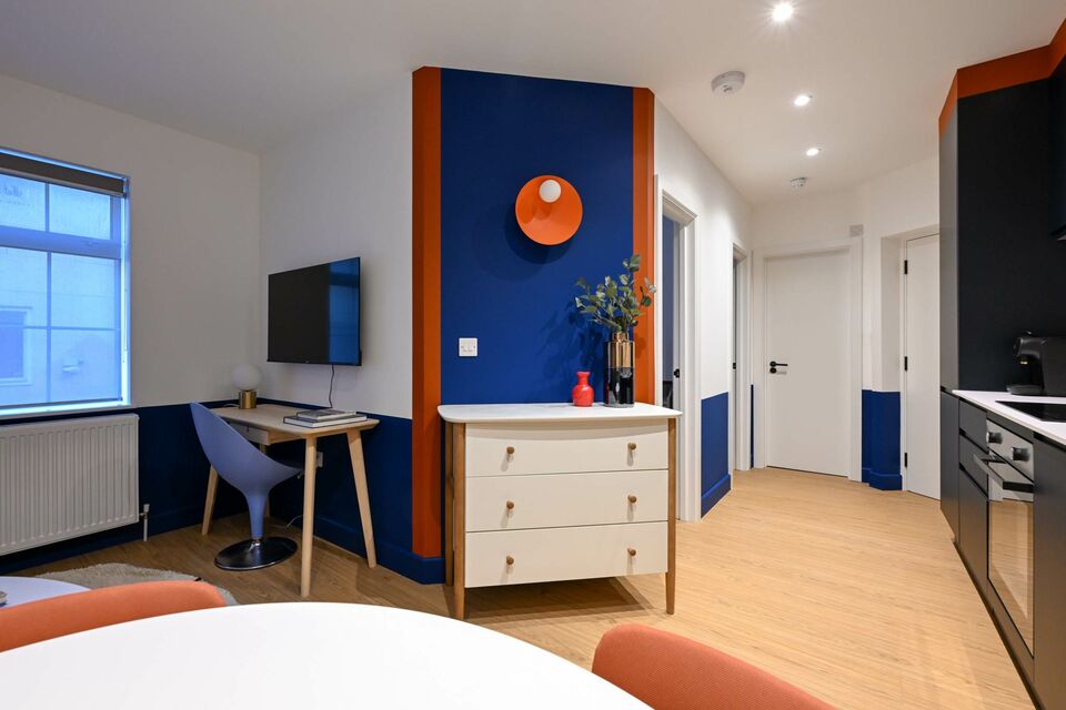 Serviced apartment, bedroom with blue accent wall in London City of London