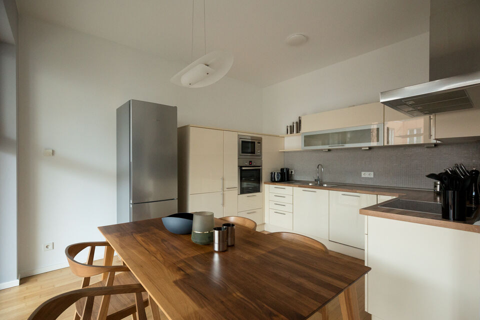 Apartment, dining area & kitchen with wooden dining table in Berlin Mitte