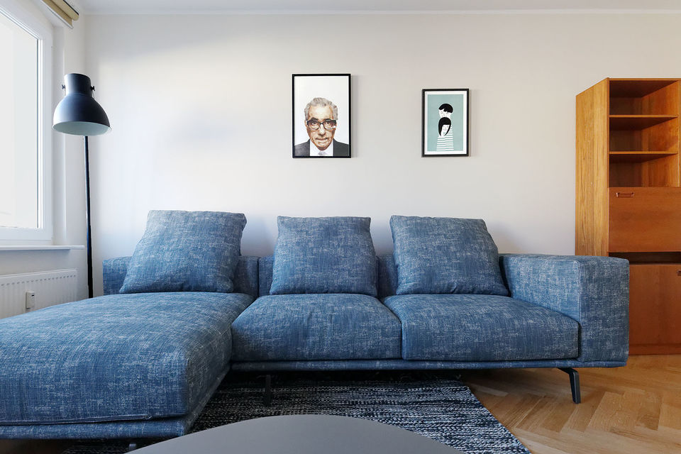 Furnished apartment, living room with blue corner sofa in Berlin Mitte