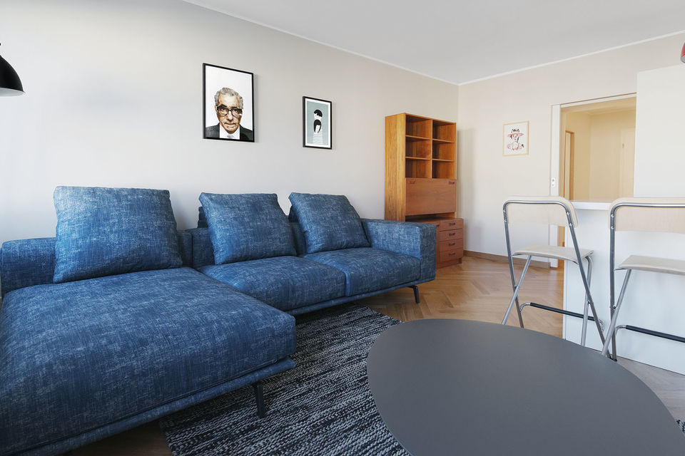 Furnished apartment, living room with blue corner sofa in Berlin Mitte