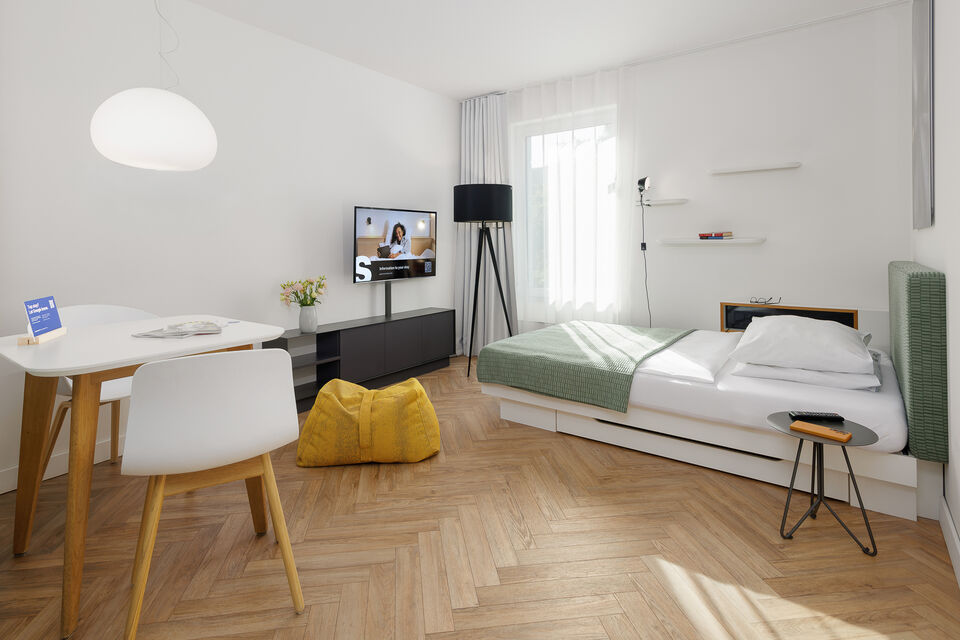 Serviced Apartment, Schlafzimmer 1 mit grünem Polsterbett in München Schwabing