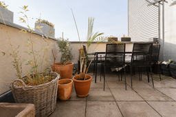 Furnished apartment, terrace with dining table and plants in Berlin Friedrichshain