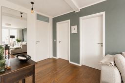 Furnished apartment, corridor with parquet flooring and sage green walls in Berlin Friedrichshain