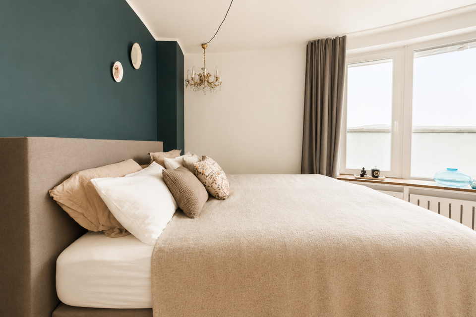 Furnished apartment, bedroom with green accent wall in Berlin Friedrichshain