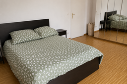 Furnished apartment, bedroom with patterned bedding in Berlin Prenzlauer Berg