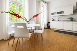 Furnished apartment, dining area and kitchen with orchid arrangement in Berlin Prenzlauer Berg