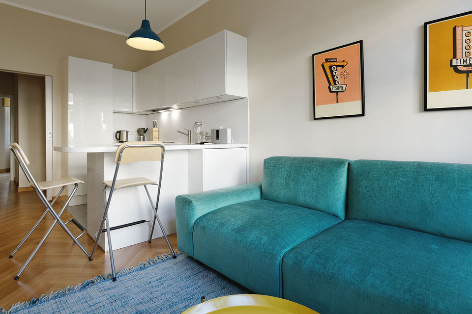Furnished apartment, living room with turquoise sofa in Berlin Mitte