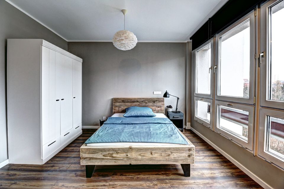 Furnished apartment, bedroom with wooden bed in Berlin Mitte
