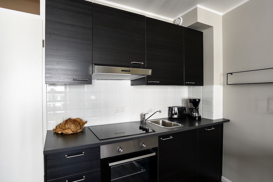 Furnished apartment, kitchen with black cabinetry in Berlin Mitte