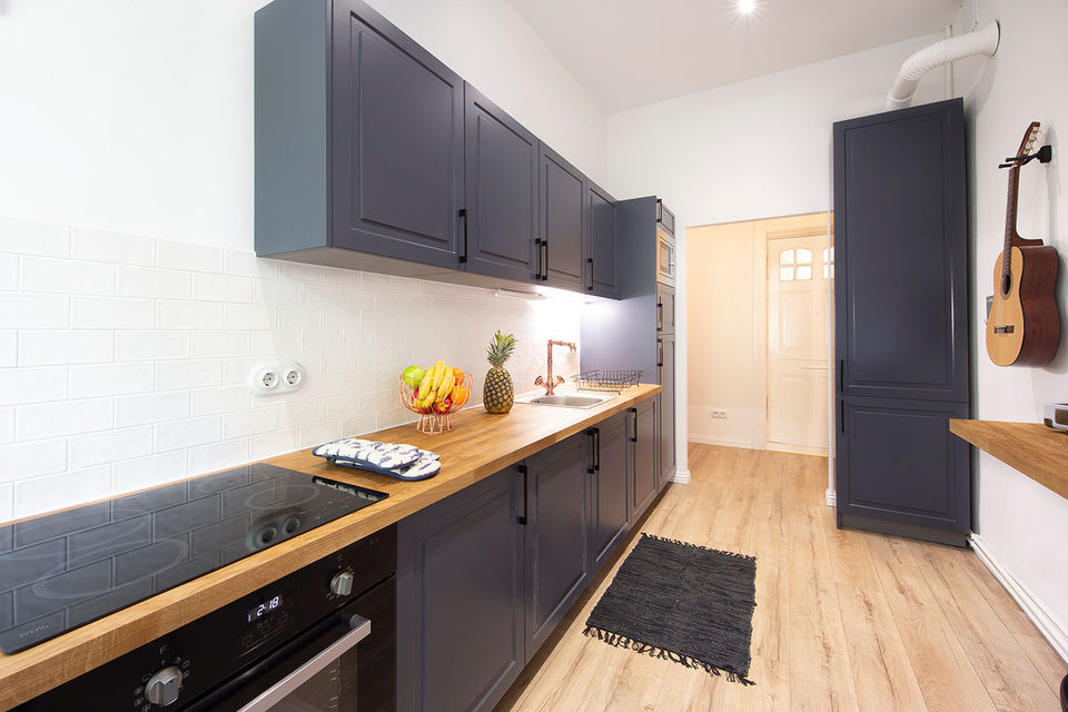 Furnished apartment, kitchen with dark cabinets and wooden countertop in Berlin Charlottenburg