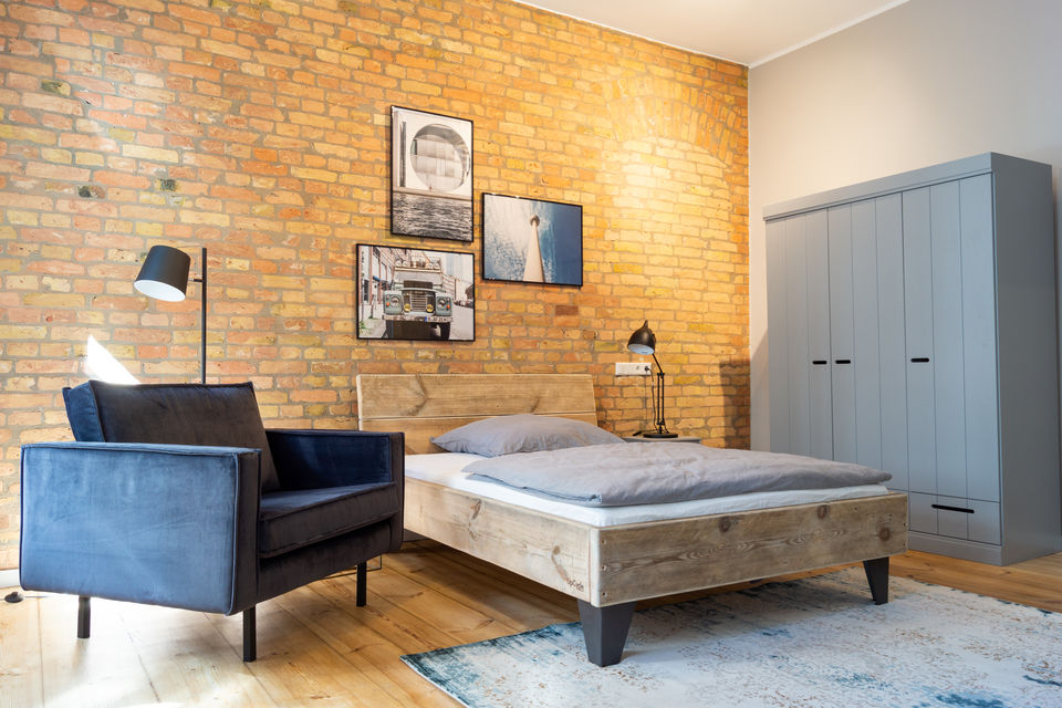 Furnished apartment, bedroom with exposed brick wall in Berlin Friedrichshain
