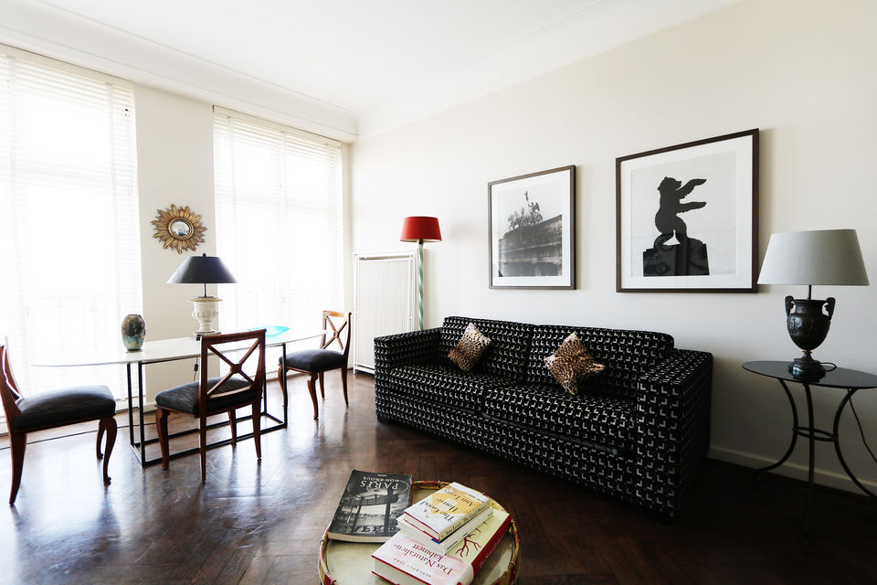Furnished apartment, living room with black designer sofa in Berlin Friedrichshain