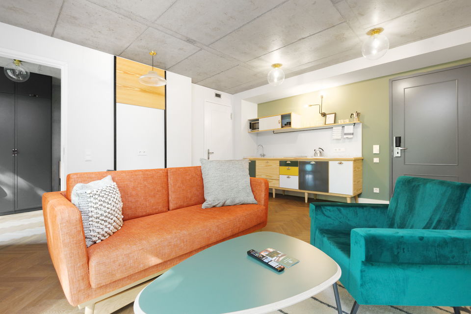 Serviced apartment, living room with colorful upholstered furniture in Berlin Mitte