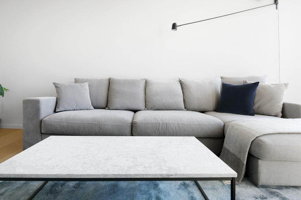 Furnished apartment, living room with gray corner sofa in Berlin Mitte