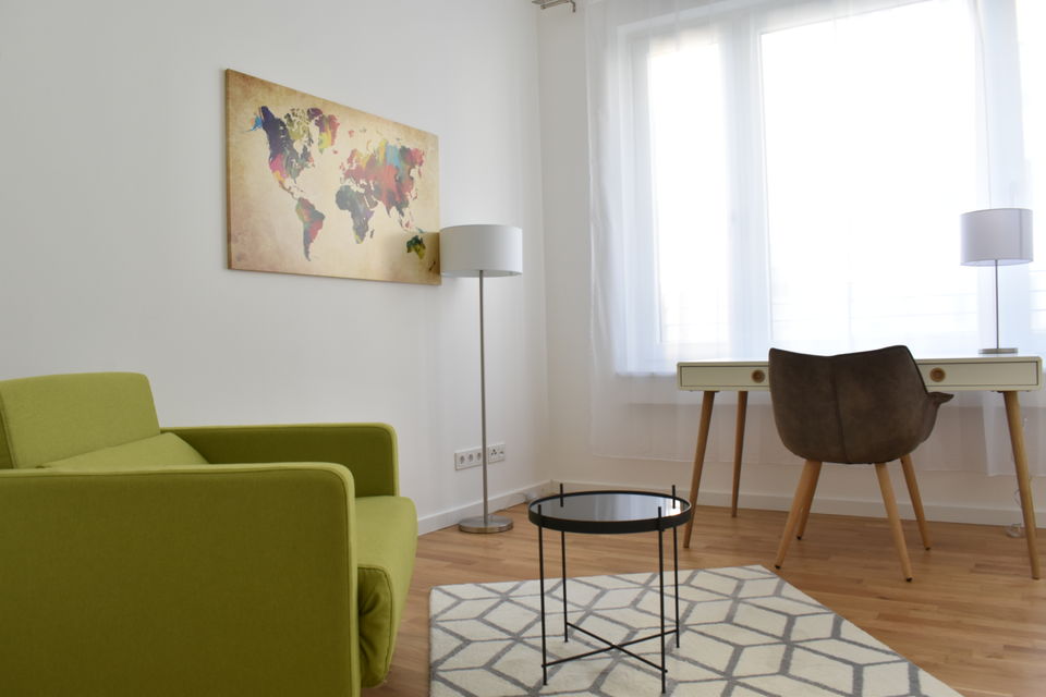 Furnished apartment, living room with green armchair in Berlin Mitte