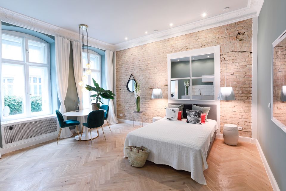 Furnished apartment, bedroom with exposed brick wall in Berlin Prenzlauer Berg