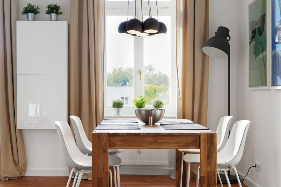 Furnished apartment, dining room with wooden table and window view in Berlin Mitte