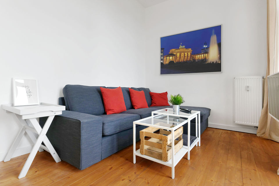 Furnished apartment, living room with blue sofa in Berlin Mitte