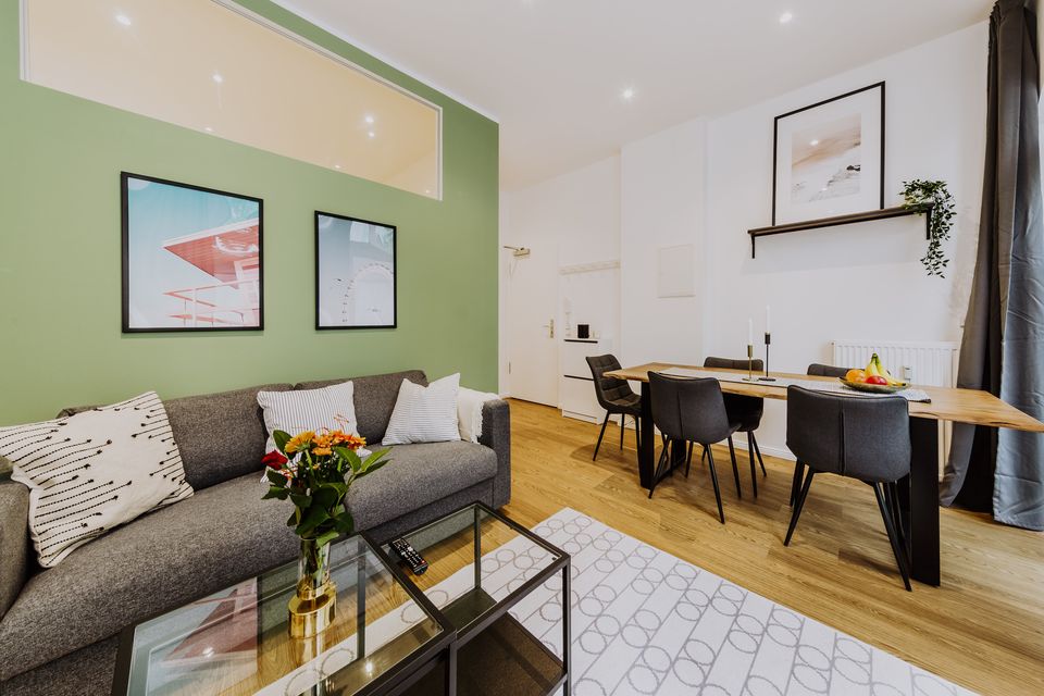 Furnished apartment, living room with green accent wall in Berlin Mitte