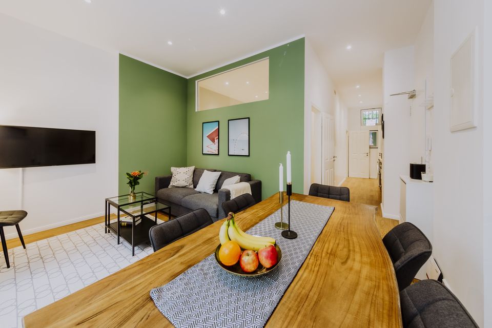 Furnished apartment, living room with green accent wall in Berlin Mitte