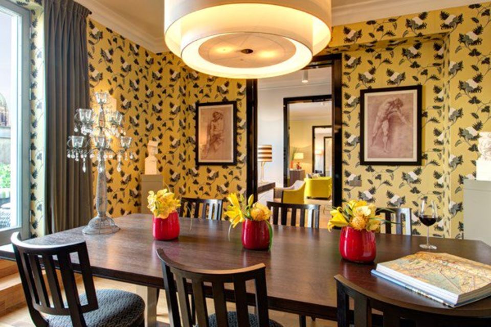 Serviced apartment, dining room with yellow bird wallpaper in Berlin Mitte