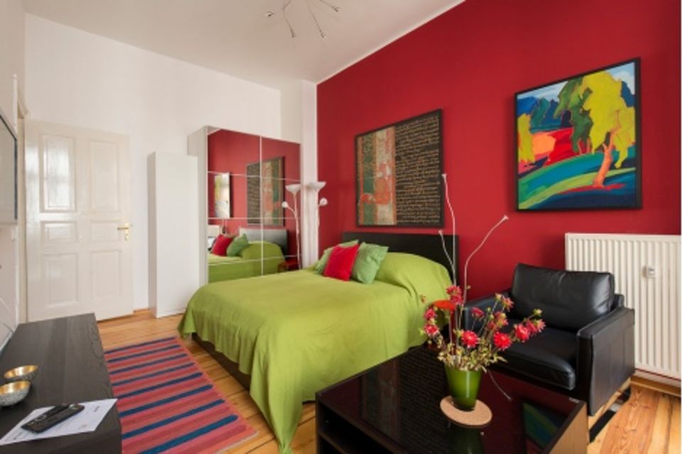 Furnished apartment, bedroom with red accent wall in Berlin Mitte