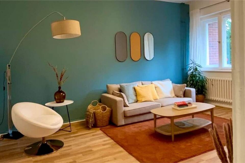 Furnished apartment, living room with turquoise accent wall in Berlin Spandau