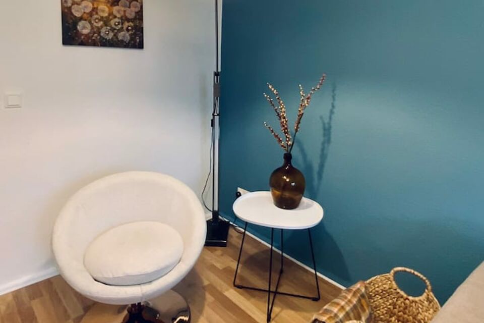 Furnished apartment, living room with modern lounge chair in Berlin Spandau