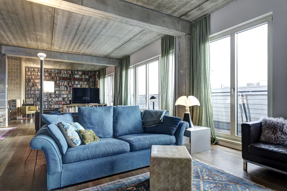 Furnished apartment, living room with blue designer sofa in Berlin Mitte