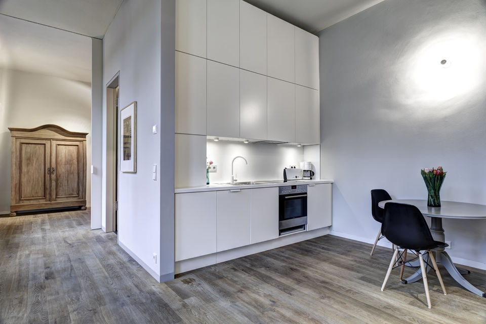 Furnished apartment, kitchen with white built-in cabinets in Berlin Friedrichshain